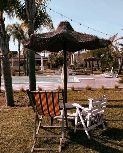 a chair and an umbrella in a park at Relais San Giovanni srls in Castellaneta