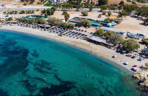 an aerial view of a beach with a group of umbrellas at Apartment by the beach in Anavissos