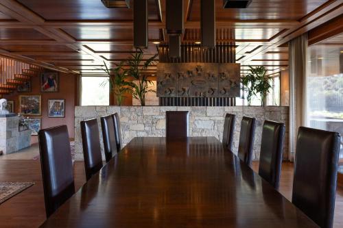 a conference room with a long table and chairs at Casakubrick mansión in Castelltersol