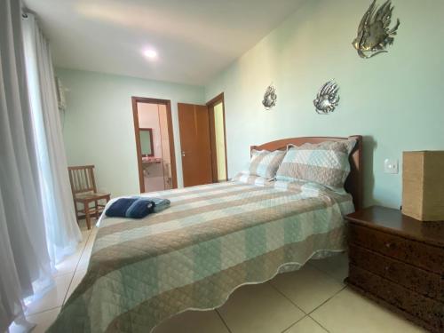 a bedroom with a bed with a blue hat on it at Movida Cabo Frio in Cabo Frio