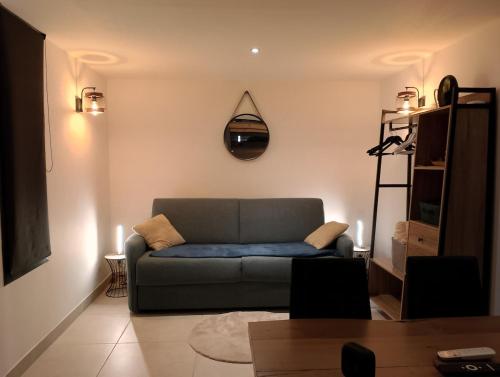 a living room with a couch and a clock on the wall at La Casa Beau site in Gap