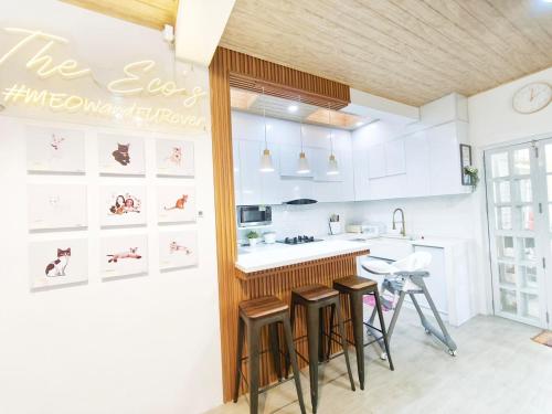 a kitchen with a counter and stools in it at Eco's Place GenTri - Family Bungalow in General Trias