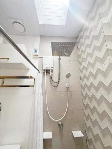 a bathroom with a shower with a shower curtain at Eco's Place GenTri - Family Bungalow in General Trias
