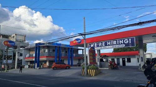 a were hiring sign in front of a gas station at Eco's Place GenTri - Family Bungalow in General Trias