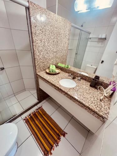 a bathroom with a sink and a mirror at DMCeara Golden Fortaleza - Praia in Fortaleza