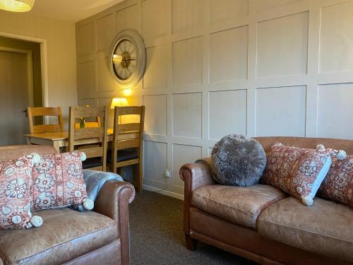 a living room with two couches and a table at Bowness Bay View in Windermere