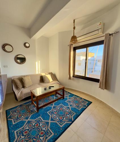 a living room with a couch and a coffee table at Lighthouse Residence in Dahab