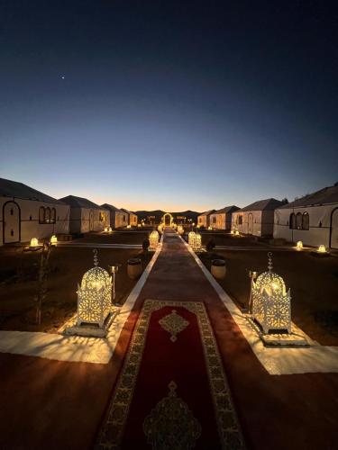 a view of a compound at night with a red carpet at Alan Tent Merzouga in Merzouga