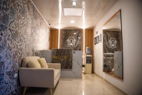 a living room with a couch and a wall at Hotel Garden House Guaviare in San José del Guaviare