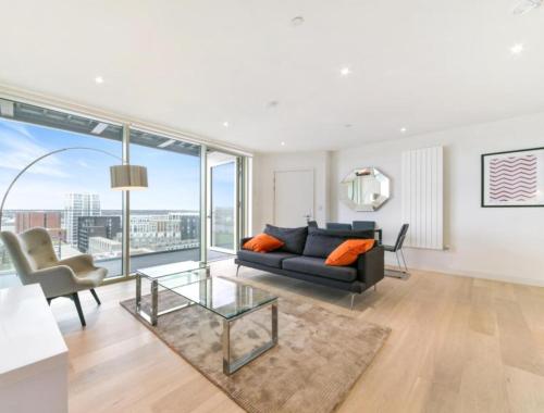 a living room with a couch and a glass table at Riverside Suites and Apartments in London