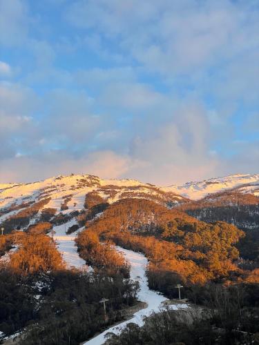 a view of a snowy mountain with a river at Schuss Alpine Club, Thredbo in Thredbo