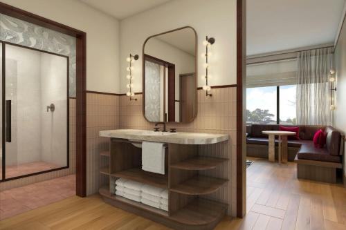 a bathroom with a sink and a mirror at The Tallison Hotel, a Tribute Portfolio Hotel in Carmel