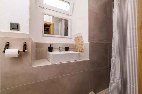 a bathroom with a white sink and a mirror at Holiday home in Grizane 51206 in Grižane
