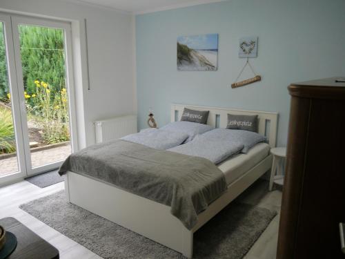 a bedroom with a bed and a large window at Ferienwohnung -Diemelaue- in Warburg