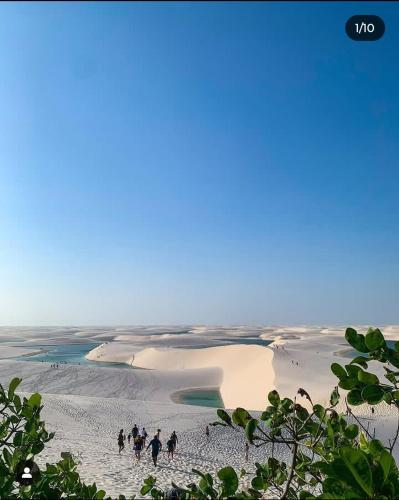 a group of people walking on a beach at Estadia in São Luís