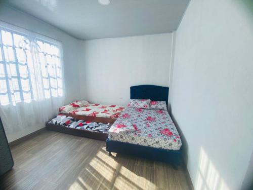 a bedroom with two beds and a window at Casa Cruz Melgar in Melgar