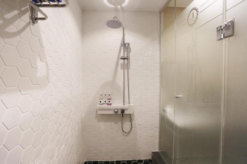 a bathroom with a shower with a glass door at Louis Hotel in Gangneung