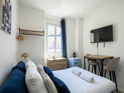 une chambre avec un lit, un bureau et une télévision dans l'établissement Cozy studio - Cannes center - 2 people, à Cannes