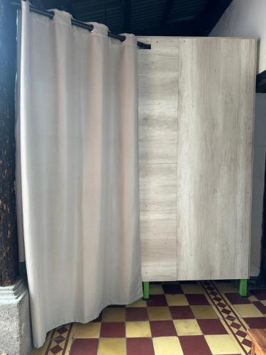 a white curtain on a wall in a room at Hostal Casa La Merced in Antigua Guatemala