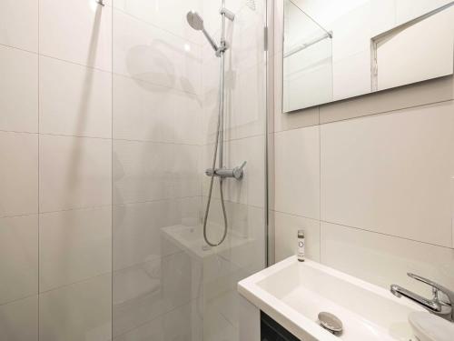 une salle de bain blanche avec une douche et un lavabo dans l'établissement Sublime studio renovated - Cannes center, à Cannes