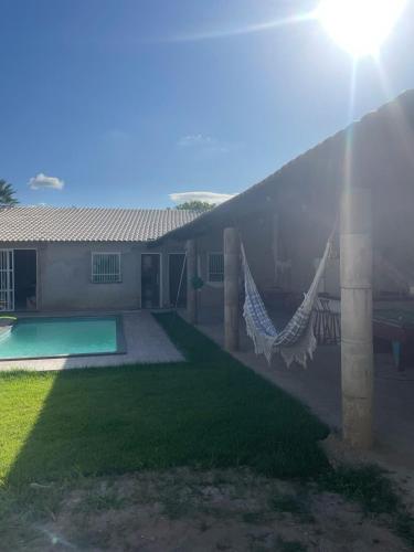 a house with a hammock in the yard at sitio para eventos in Caucaia
