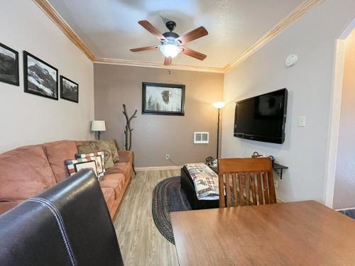 a living room with a couch and a ceiling fan at Condo at Cedar Breaks Lodge in Brian Head, UT in Brian Head