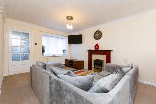 a living room with a couch and a fireplace at Durham 3Bedroom Home Away From Home in Durham