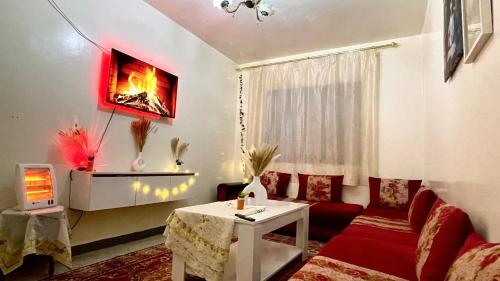 a living room with a couch and a table at Cozy Airport apartment only 5 minutes walk in Marrakech