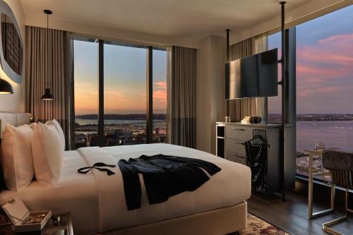 a hotel room with a bed and a large window at Hotel Indigo Auckland by IHG in Auckland