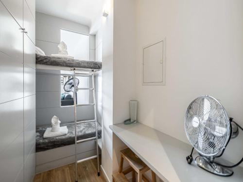 Cette petite chambre dispose d'un ventilateur et d'un bureau. dans l'établissement Charming Appt - 1BD 4P- sea view - Antibes Centre, à Antibes