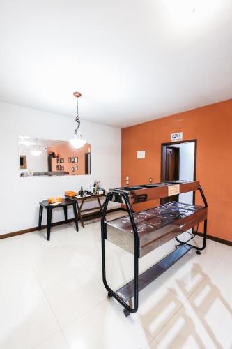 a room with two benches and a table in it at Hotel Sanches in São Mateus