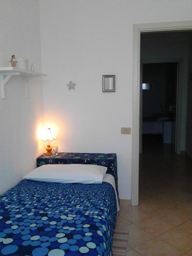 a bedroom with a bed and a lamp on a table at Bed And Breakfast Catherina in Ponsacco
