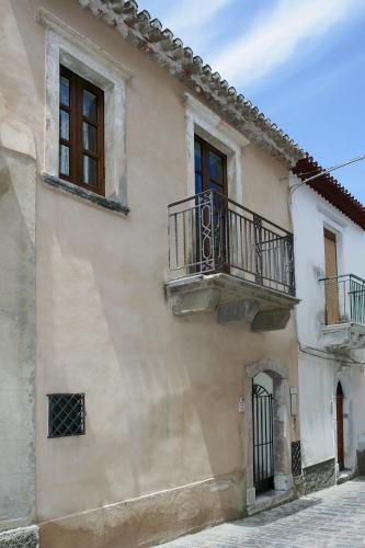 a building with two balconies on the side of it at B&B Il Padrino in Savoca 