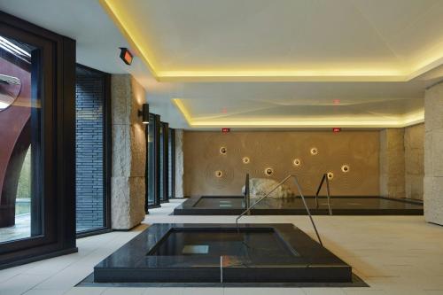 a lobby with a pool in the middle of a room at The Westin Yilan Resort in Yuanshan