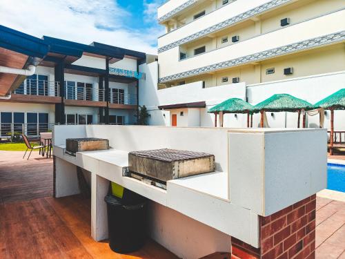 a building with a patio and a swimming pool at Cyan Sea Suites in Bolinao