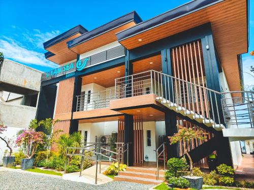 a building with a staircase in front of it at Cyan Sea Suites in Bolinao