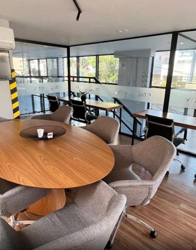 a conference room with a wooden table and chairs at Royal Luxury 305 in Poços de Caldas