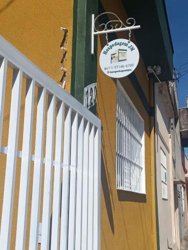 a building with a sign on the side of it at Quartos para alugar em itu Hostel Jm in Itu