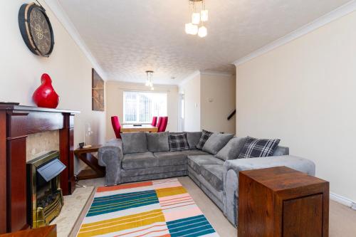 a living room with a couch and a fireplace at Durham 3Bedroom Home Away From Home in Durham