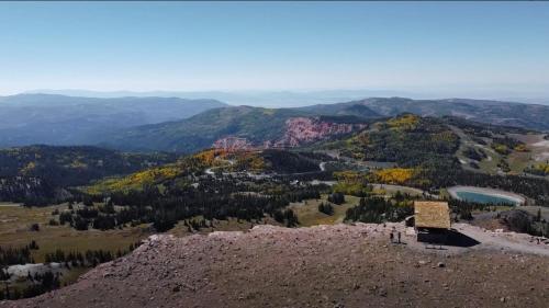 a view from the top of a mountain with a sign at 1BR 1BA for 5 Close to Outdoor Activities in Brian Head