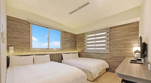 Postel nebo postele na pokoji v ubytování Huaxin Hotel