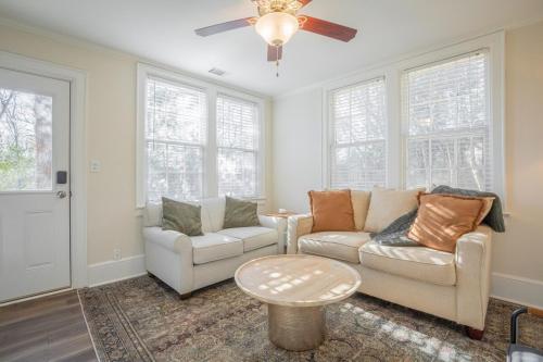 a living room with a couch and a table at Classic City Apartment w Firepit in Athens