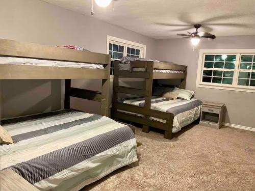 a bedroom with two bunk beds and a ceiling fan at Cedar creek lake front home with Gorgeous Sunset in Kemp