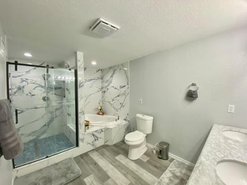 a bathroom with a shower and a toilet and a sink at Cedar creek lake front home with Gorgeous Sunset in Kemp