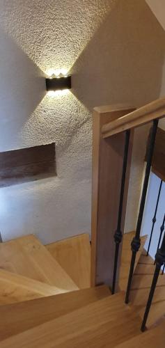 a room with a staircase with a light on the ceiling at Sancerre centre, Appartement duplex et ou Chambre indépendante, modulable in Sancerre