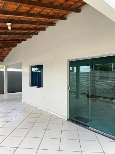an empty room with a glass door on a building at Casa, ótima localização, fantástica in Boa Vista