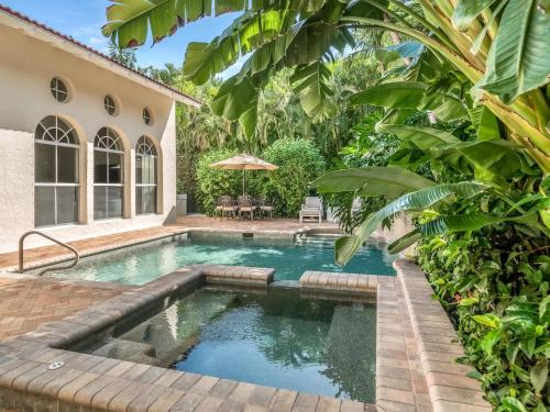 a swimming pool in the backyard of a house at Casa Captiva - Deluxe 5 Bedroom Villa Steps to Beach in Captiva