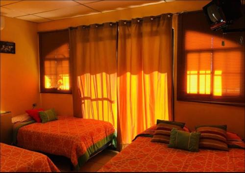 a bedroom with two beds and a window at Casa central in San Juan del Sur