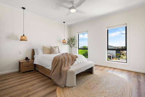a white bedroom with a bed and a window at The Sandbar Stay - Wi-Fi, BBQ, Parking in Middleton