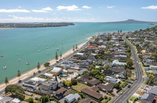 an aerial view of a suburb next to a beach at A Home Away from Home - Bucklands Beach Luxury 3-Bedroom Garden Villa in Auckland